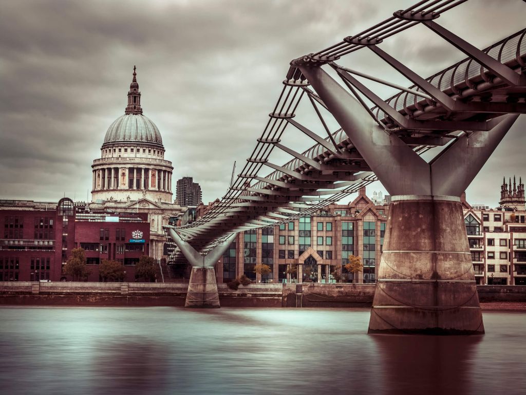 View of St Paul's Cathedral and Millennium Bridge from river thames, London, UK